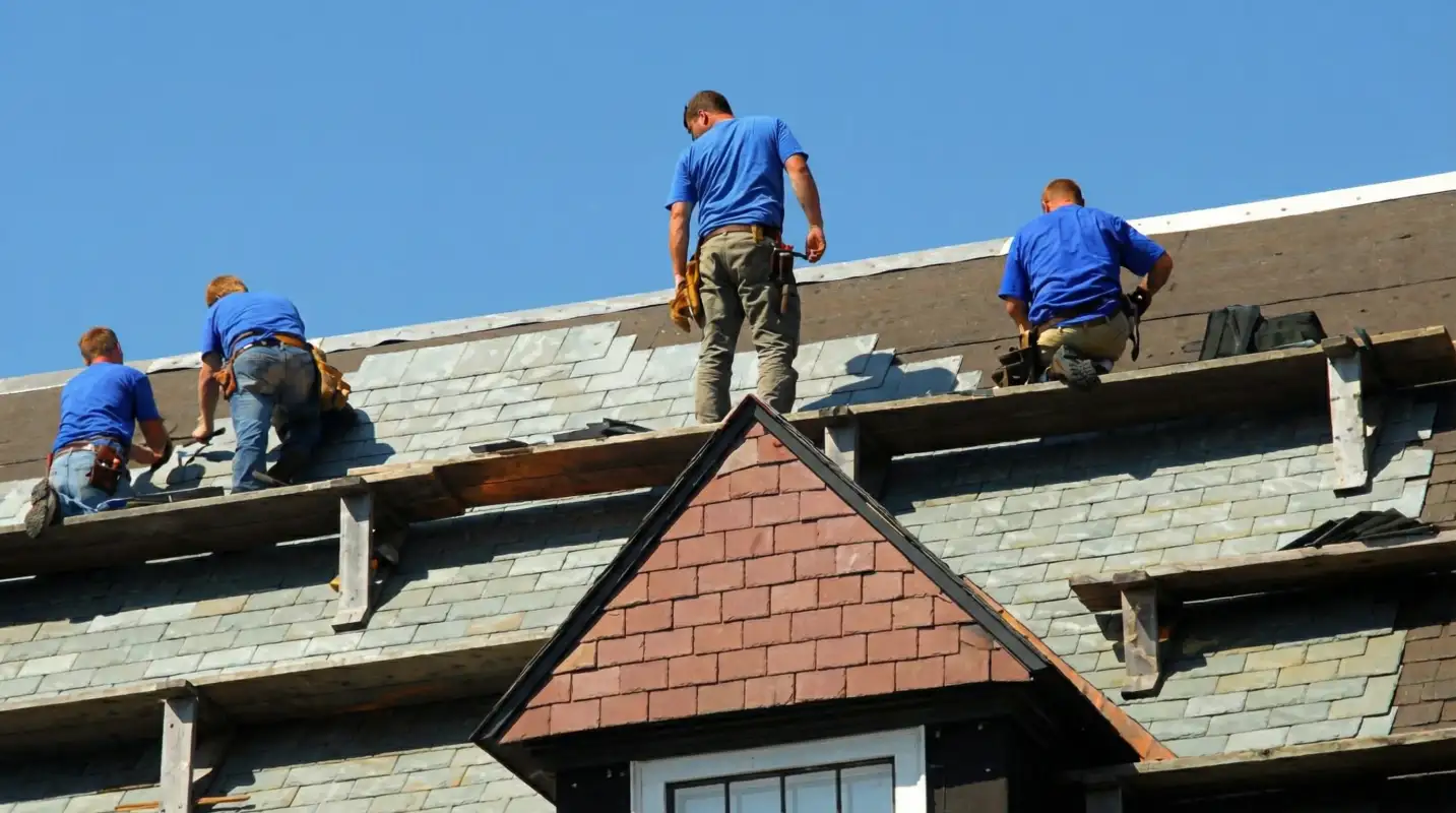 Roof replacement in progress with a team of professional contractors installing new shingles on a residential home in Sacramento, CA